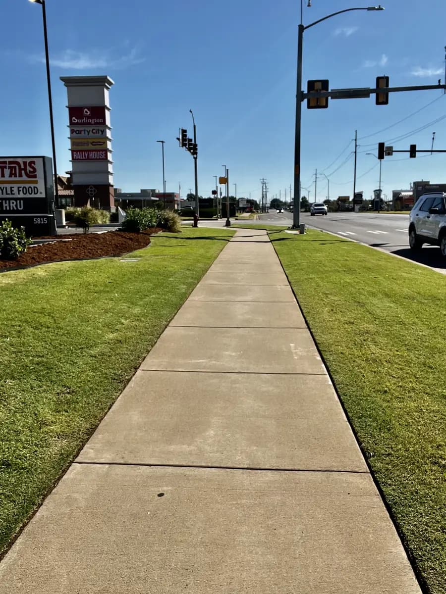 Large commercial roadside lawn maintained by Greenline