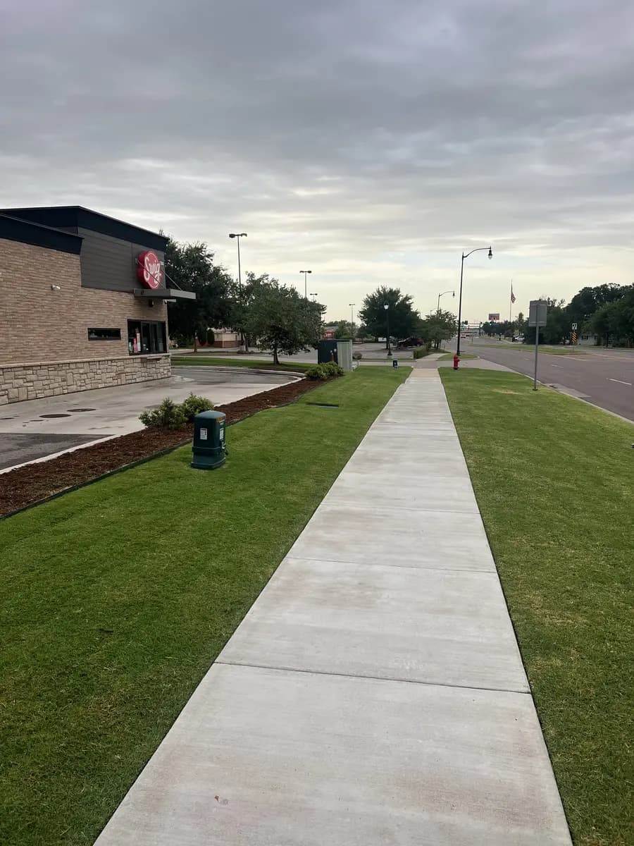 Clean commercial turf and edging along a public sidewalk